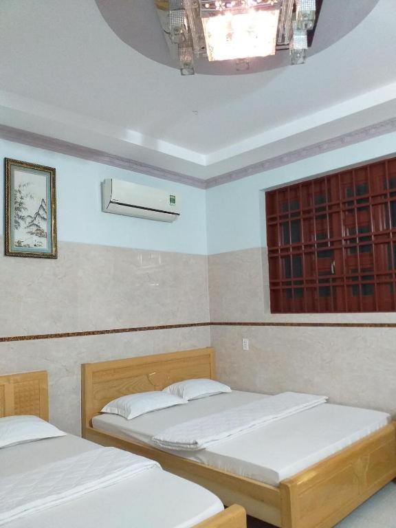 Voodi või voodid majutusasutuse Nhà Nghỉ Nguyên Anh toas