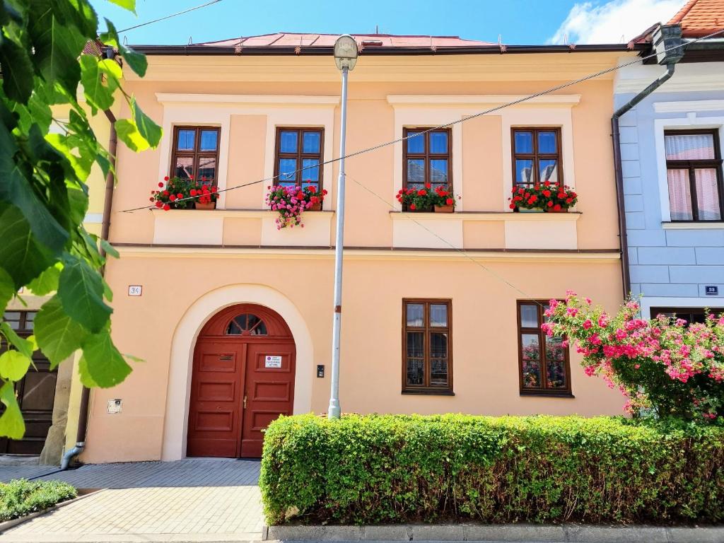 a house with flower boxes on the windows at Apartment in a historical house in the center of Levoča in Levoča