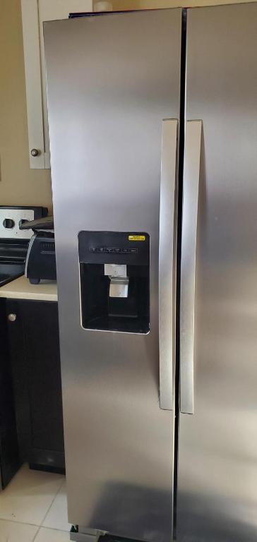 a stainless steel refrigerator with a dispenser on it at Hillside Sunrise, 2 Bed 2 Bath in Gated Community, close to beach, food, clubs & shopping Free Parking, Free Wi-Fi in Montego Bay
