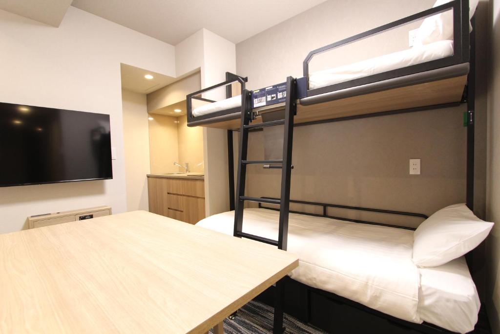 Postel nebo postele na pokoji v ubytování KOKO HOTEL Residence Asakusa Tawaramachi