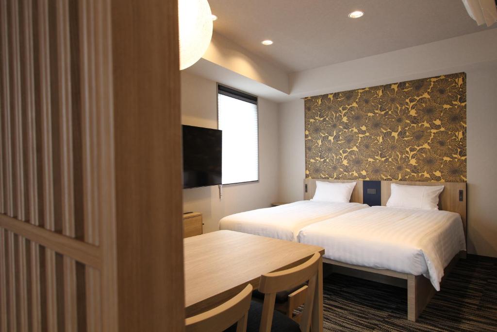 Postel nebo postele na pokoji v ubytování KOKO HOTEL Residence Asakusa Tawaramachi