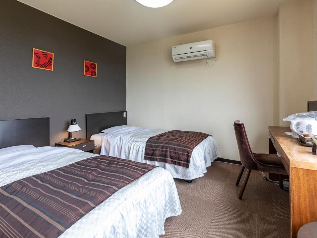 Postel nebo postele na pokoji v ubytování Tabist Hotel Kurama Hikone
