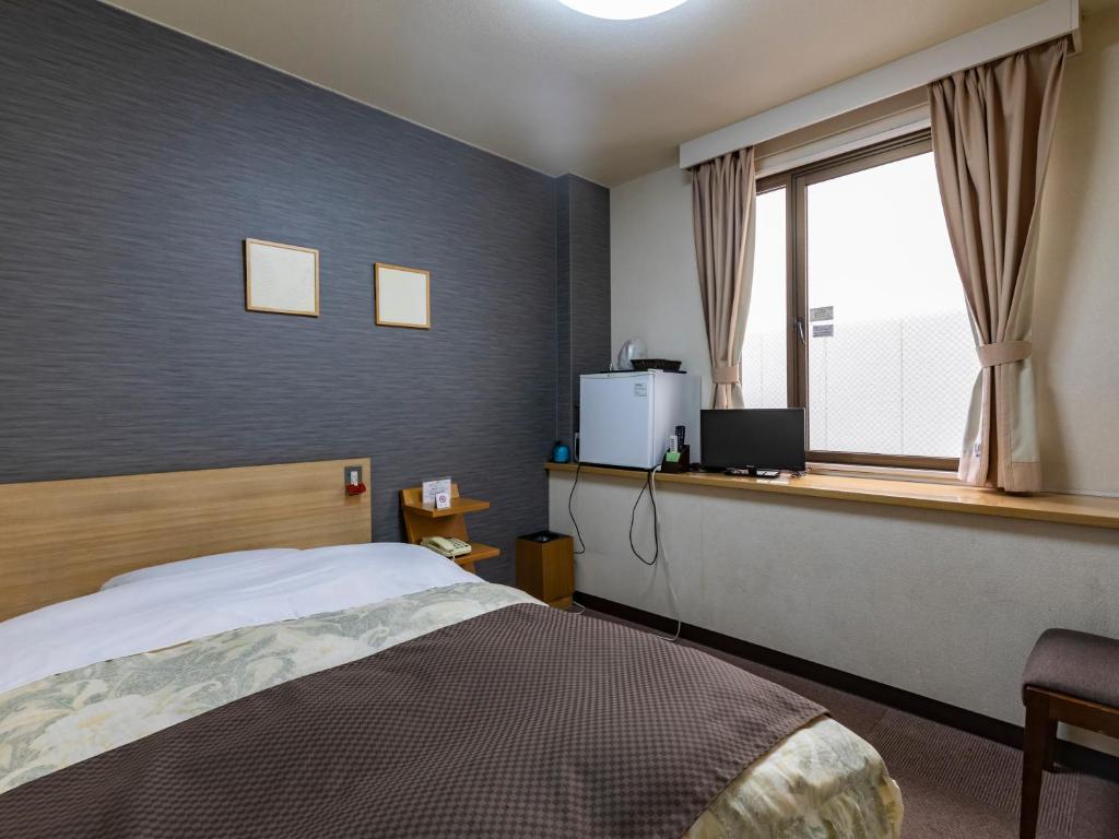 Postel nebo postele na pokoji v ubytování Tabist Hotel Kurama Hikone