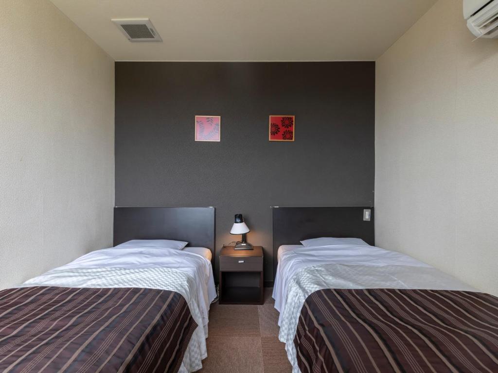Postel nebo postele na pokoji v ubytování Tabist Hotel Kurama Hikone