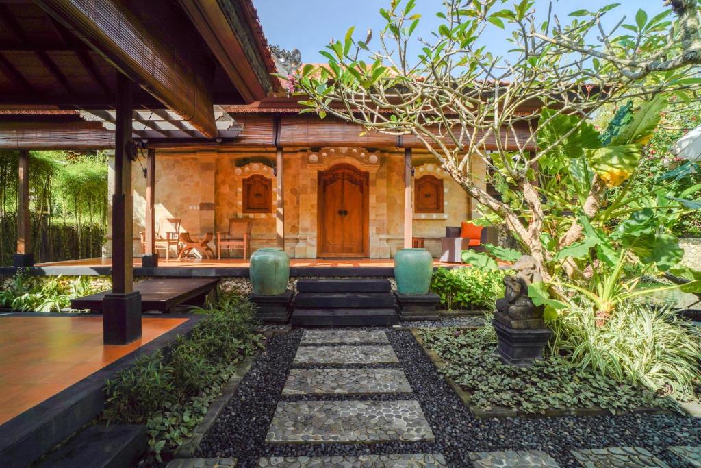 a house in the middle of a garden at Giri Bhagawan Villas & Spa in Nusa Dua