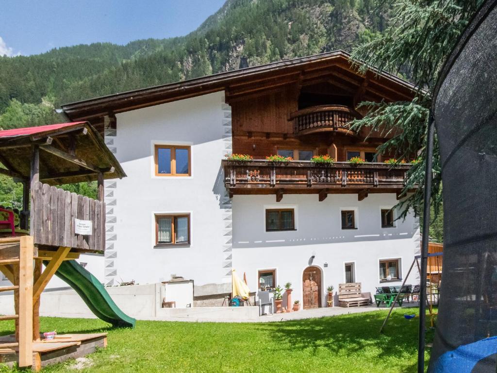 a house in the mountains with a playground at Cozy Holiday Home in Tyrol near Ski Area in Oetz