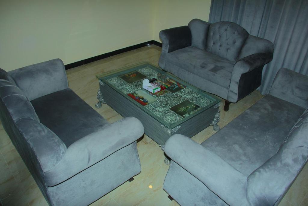a living room with two chairs and a coffee table at Move-N-Pick Murree in Murree