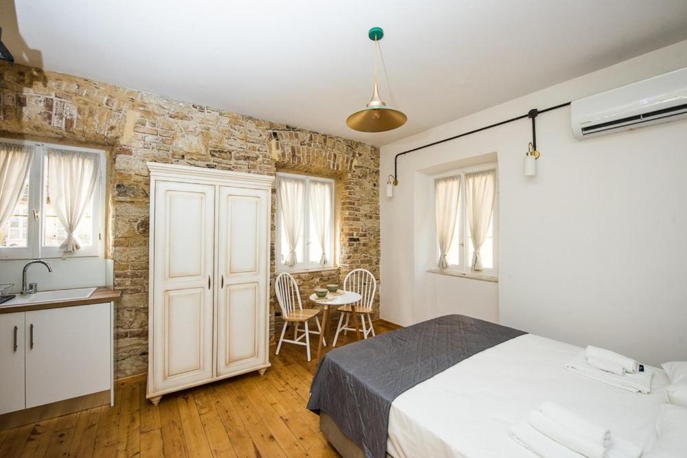 A bed or beds in a room at Calista Liston Corfu 2