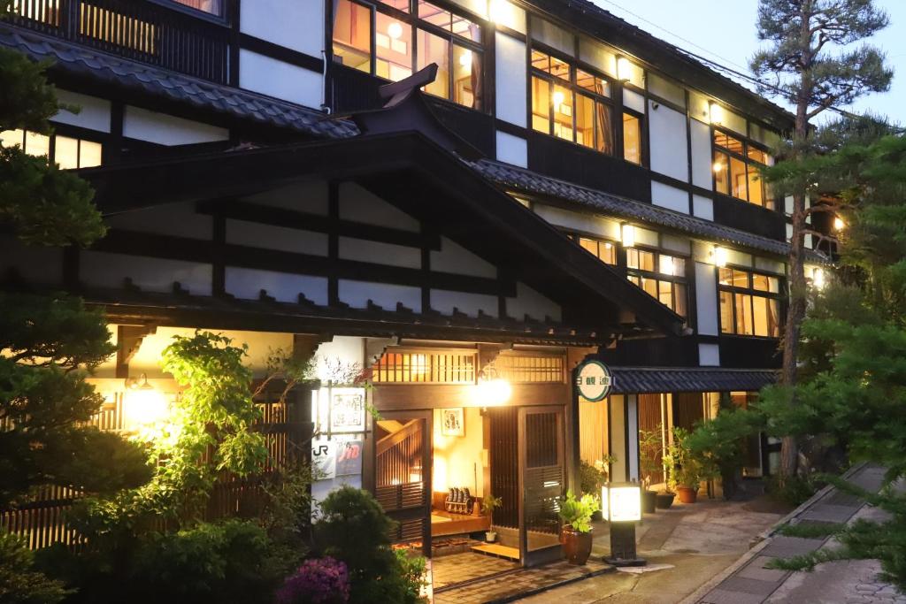 an exterior view of a building at night at 野沢温泉　奈良屋旅館 in Nozawa Onsen