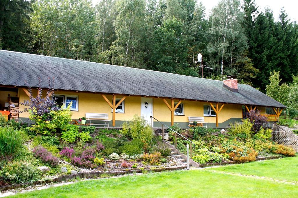 a house with a garden in front of it at Apartmány pod Ještědem in Liberec