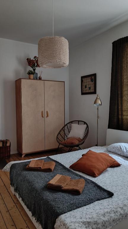 a bedroom with a bed with two towels on it at Vintage Anna Apartment in Kuldīga