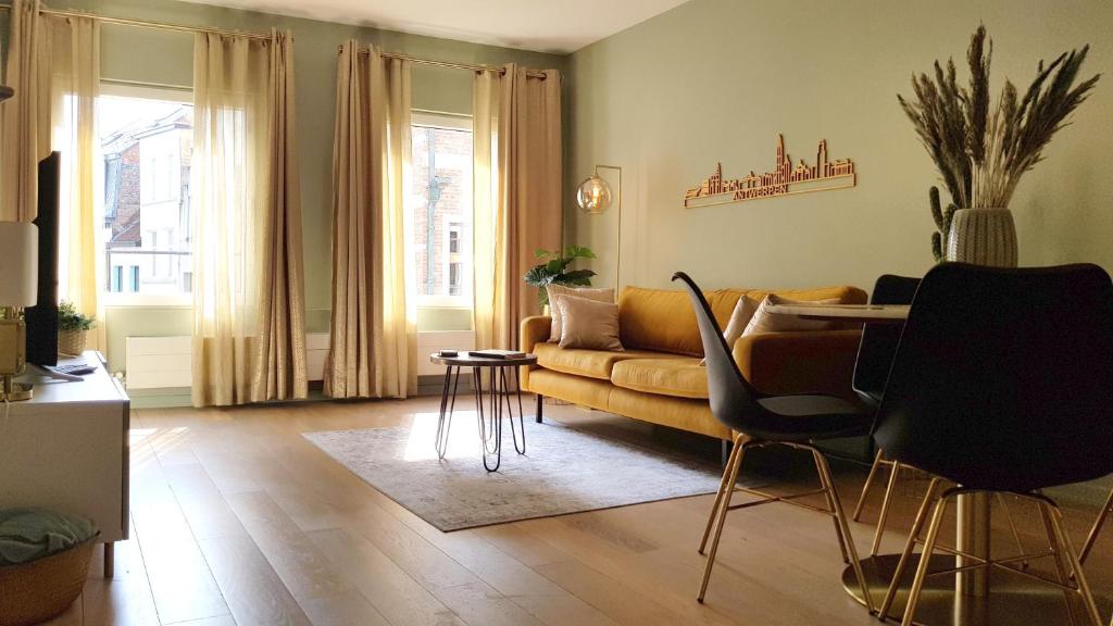 a living room with a couch and a table at BnB Antwerpen - CHIQUE in Antwerp
