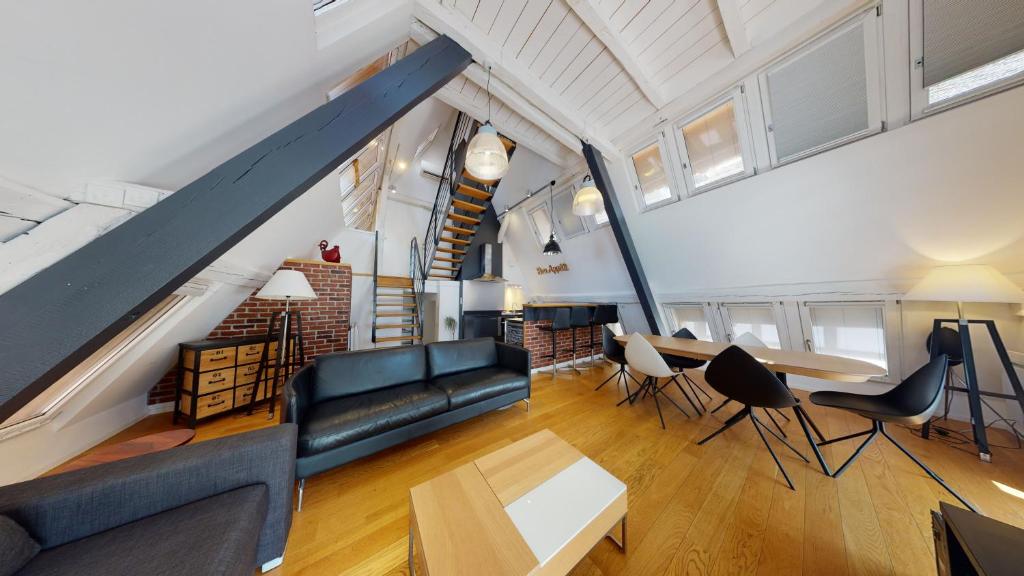 a living room with a couch and a table at Le Lohkäs - LOFT Triplex Ultra Design Petite France in Strasbourg