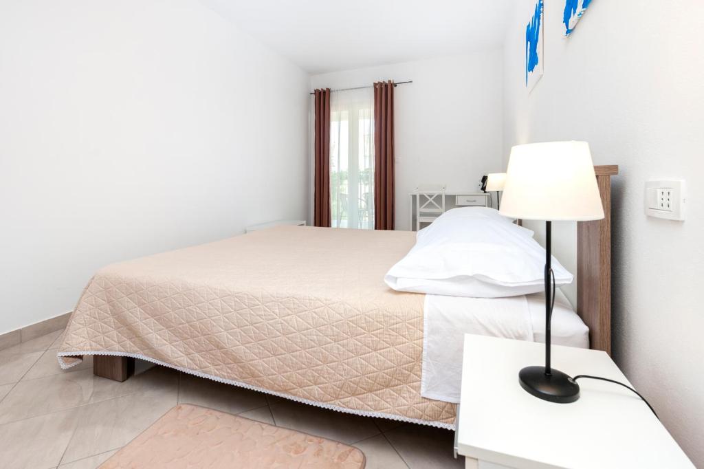 Postel nebo postele na pokoji v ubytování Apartments Vinko