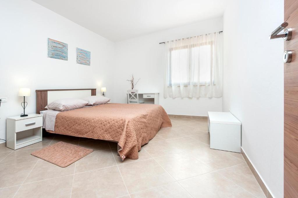 Postel nebo postele na pokoji v ubytování Apartments Vinko