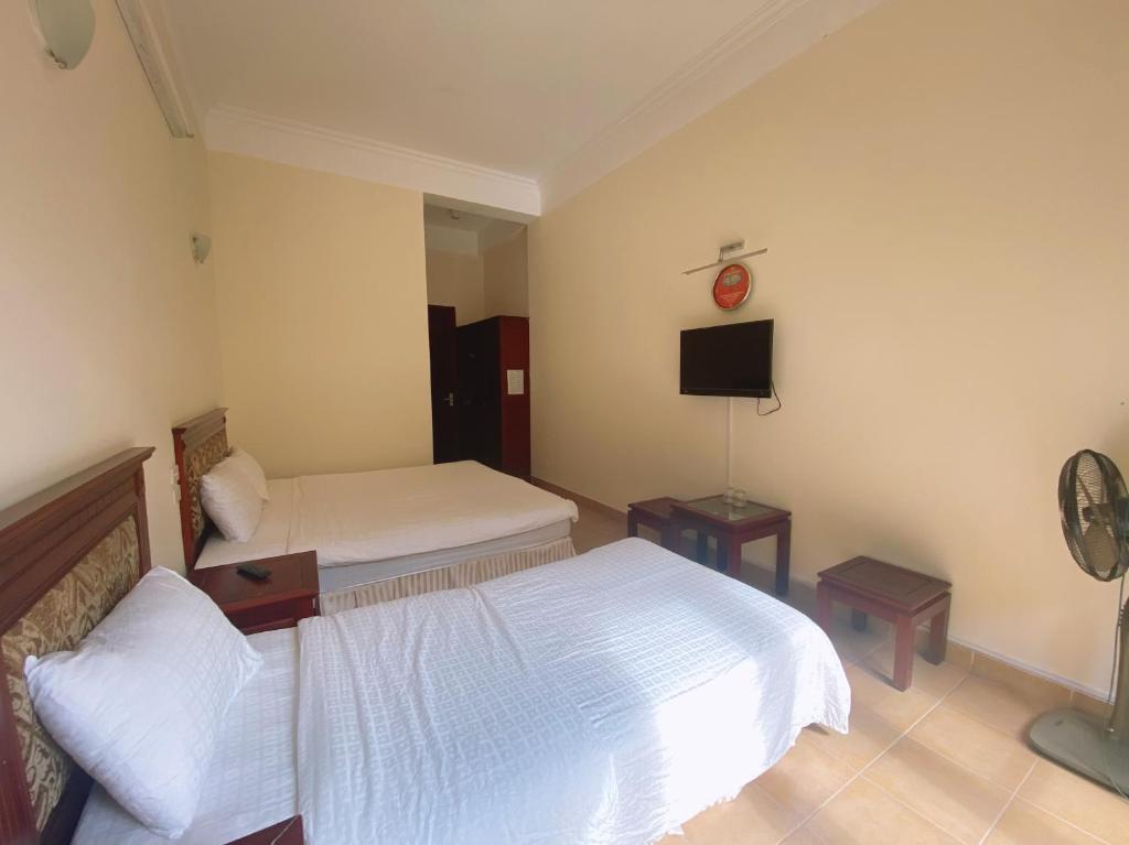 Postel nebo postele na pokoji v ubytování An Phú Motel Tam Đảo