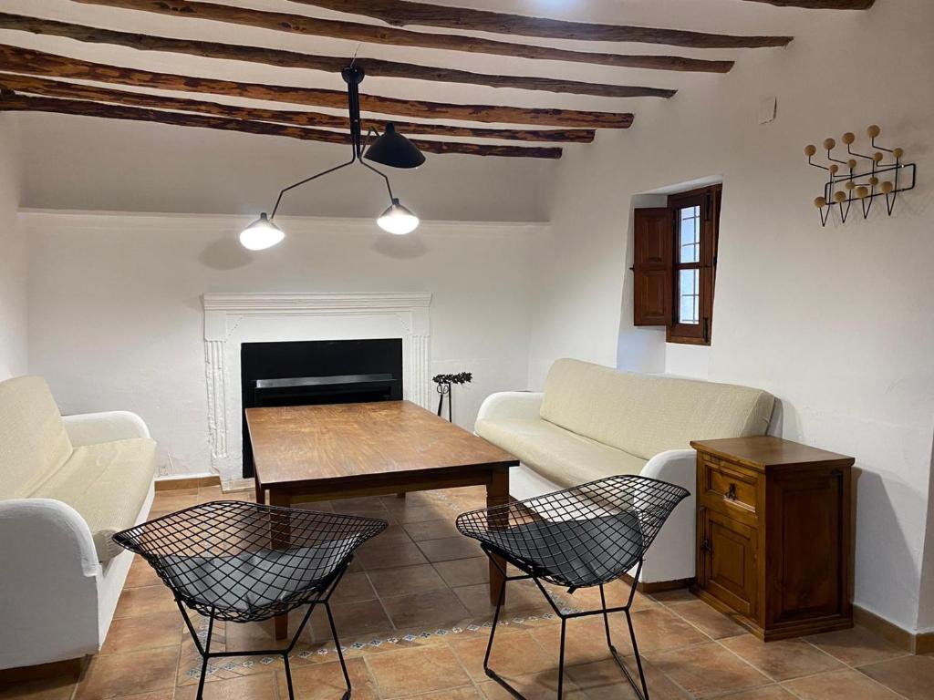 a living room with a couch and a table and chairs at Casas Mulero Y Pastor in Férez