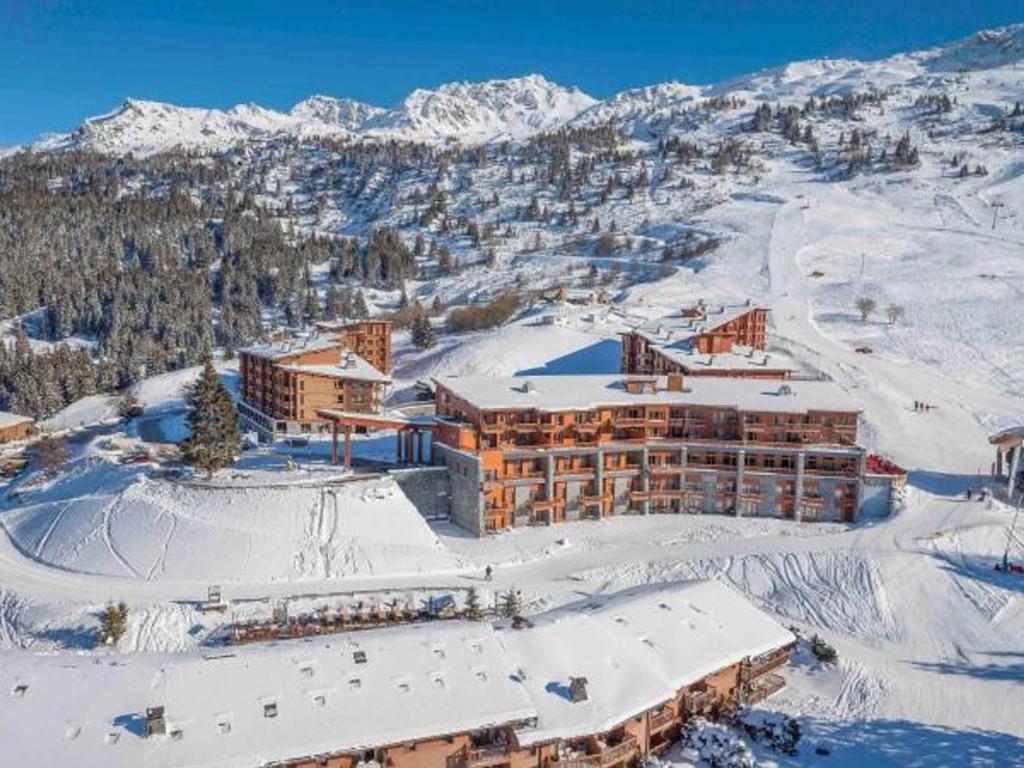 a resort in the snow with snow covered mountains at Appartement Les Arcs 1800, 2 pièces, 4 personnes - FR-1-346-318 in Arc 1800