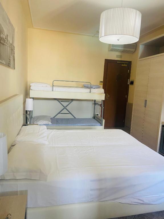 Postel nebo postele na pokoji v ubytování Hotel Bella Riviera Lungomare