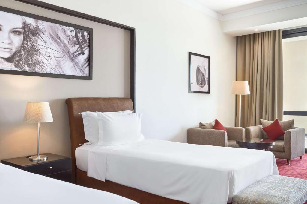 A bed or beds in a room at Radisson Blu Hotel & Convention Center, Alexandria
