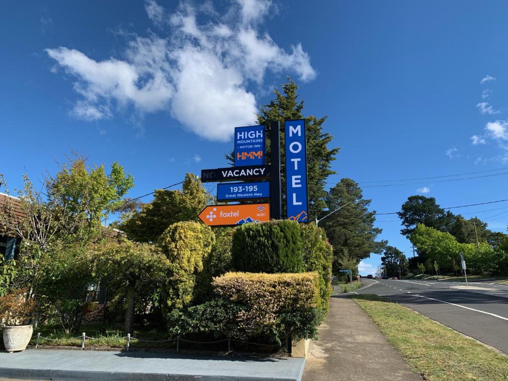 a sign for a gas station on the side of a road at High Mountains Motor Inn in Blackheath