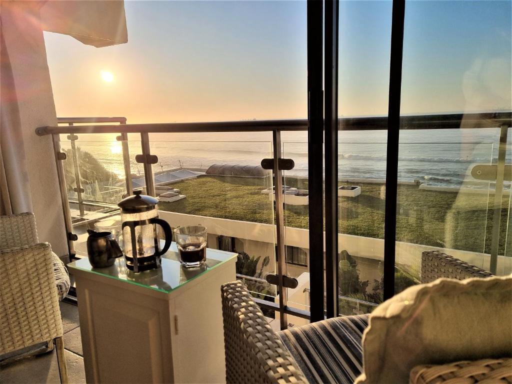 a room with a balcony with a view of the ocean at 405 Bermudas - by Stay in Umhlanga in Durban