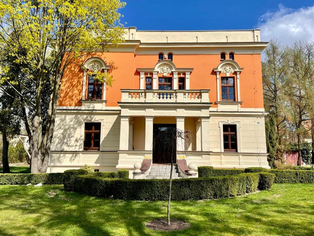 a large house with a balcony on top of a yard at Happy Living Villa in Wrocław