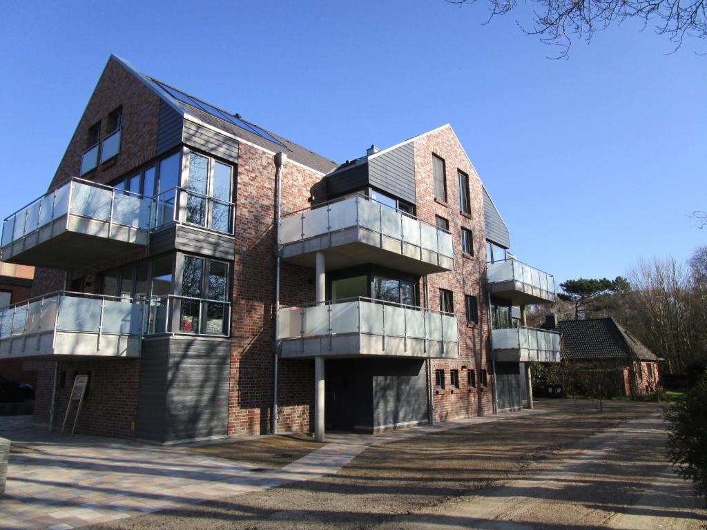 a building with balconies on the side of it at Ferienwohnung "Strandläufer 1" in Böhl