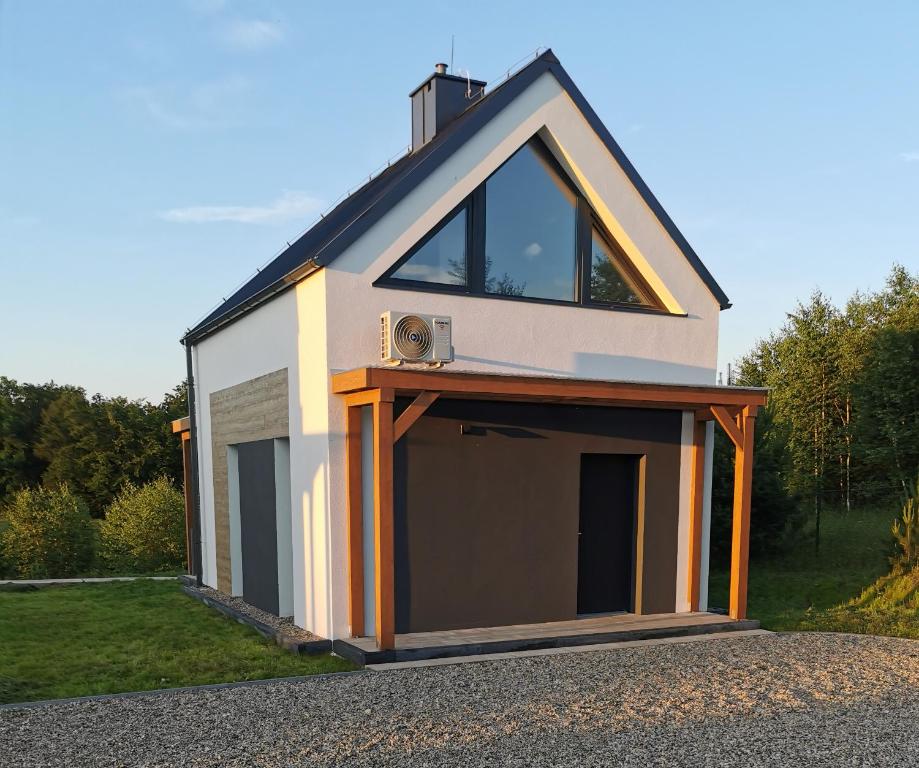 a small house with a garage on top of it at Raduńskie Wspomnienia in Przewóz