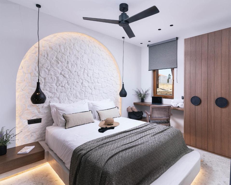 a bedroom with a bed and a ceiling fan at Kedros Katikies in Kalamaki Heraklion