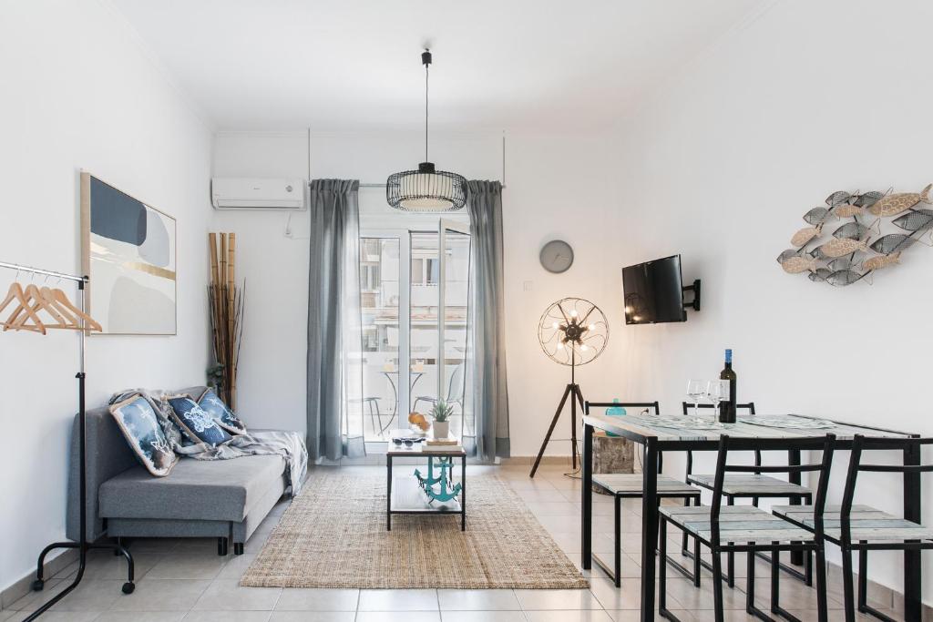 a living room with a couch and a table at Aegean style, city center studio next to Acropolis in Athens
