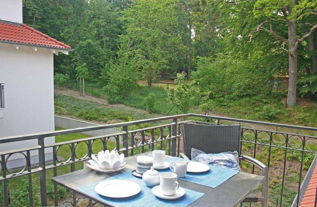einen Tisch mit Tellern und Tassen auf einem Balkon in der Unterkunft Haus Meeresblick - Ferienwohnung Am Strand (Ref. 128682u2) in Baabe
