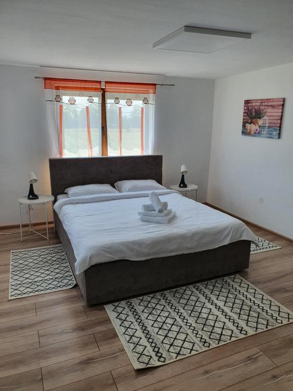 a bedroom with a large bed and a rug at Casa Saga in Gura Humorului