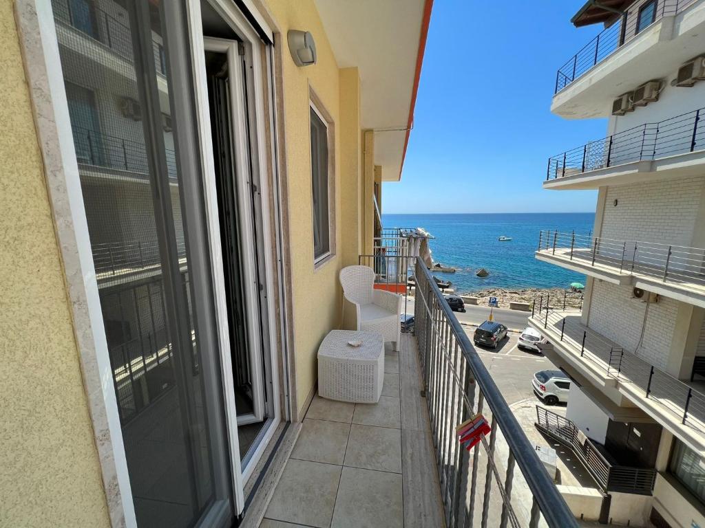 a balcony with a view of the beach at B&B Le Onde Del Mare in Gallipoli