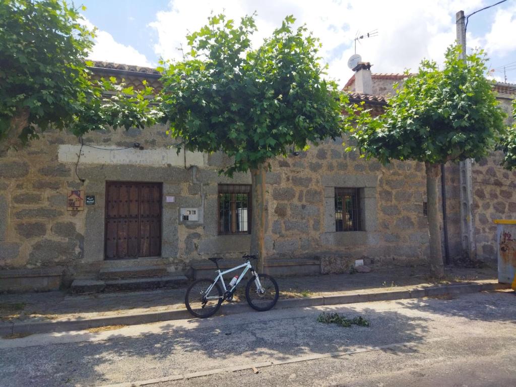 a bike parked in front of a building at Las Henrenes 