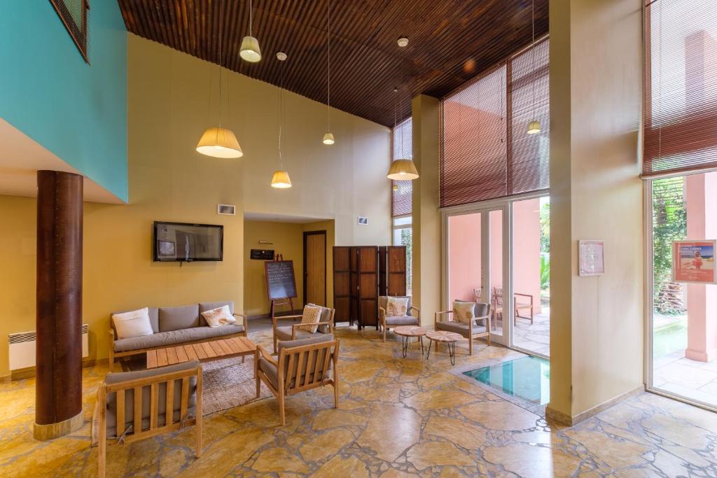 a living room with a couch and a table at Résidence Pierre & Vacances Premium Port Prestige in Antibes