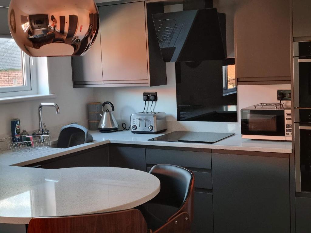 a kitchen with a table and a counter top at Holiday Apartment Beverley in Beverley