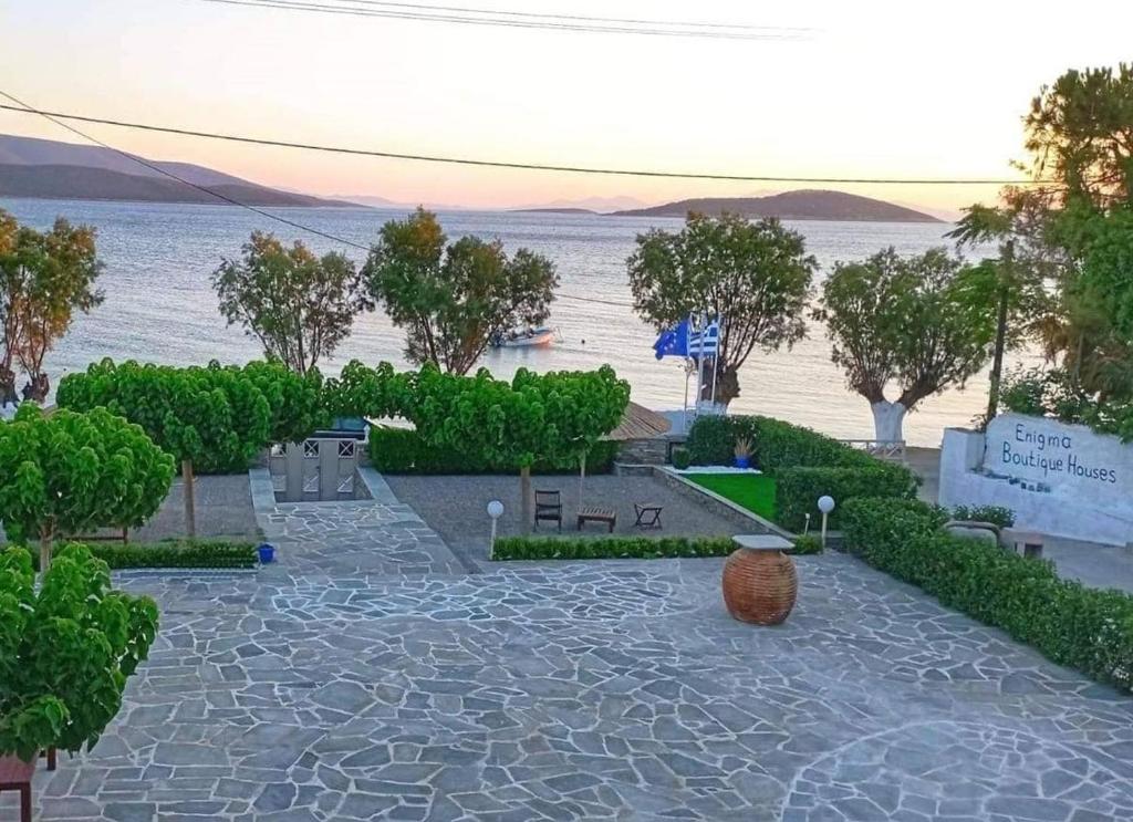 a rendering of a park with a view of the water w obiekcie Enigma Boutique Houses Votsalo w mieście Marmari