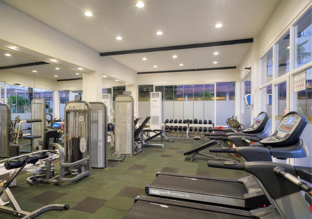 a gym with several treadmills and cardio machines at Grand Park Lara Hotel in Lara