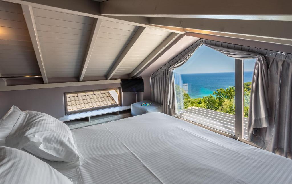 A bed or beds in a room at Ilvy Suites Sivota