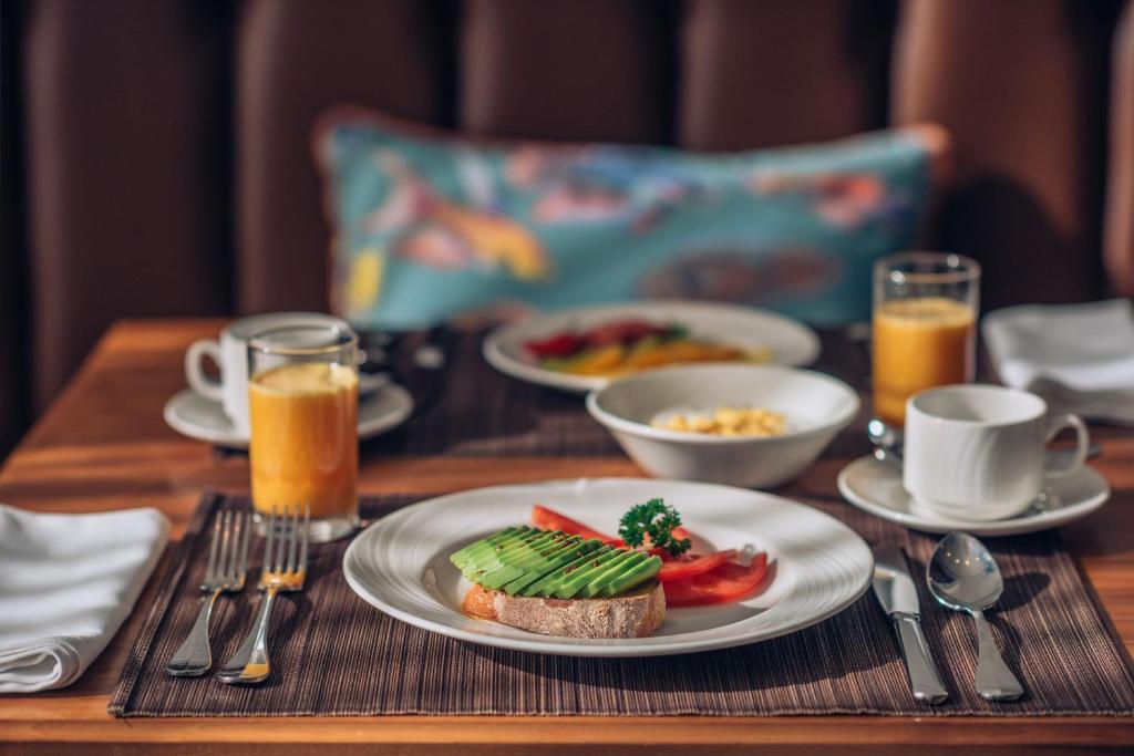 a wooden table with a plate of food on it at Iberostar Waves Slavija in Budva