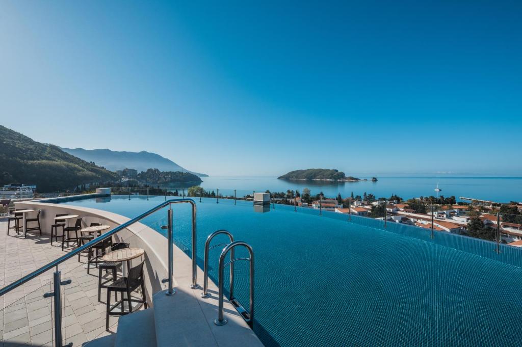 a swimming pool with a view of the ocean at Iberostar Waves Slavija in Budva