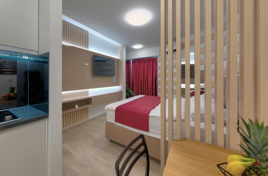 a bedroom with a bed and a table and chair at Luxury Studio Yasmine Downtown in Mostar