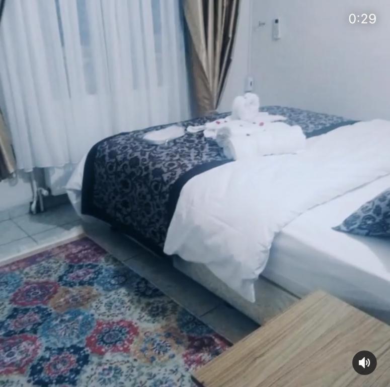 a bedroom with a bed with a teddy bear on it at Yağız İndigo Blue in Şile