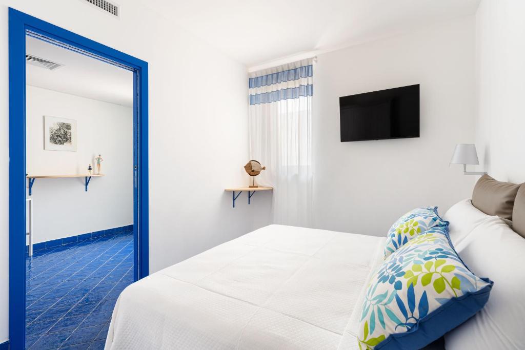a bedroom with a bed and a mirror at Don Leonardo - pool and wellness in Polignano a Mare