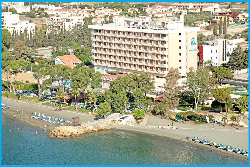 a view of a beach with a hotel and buildings at Poseidonia Beach Hotel in Limassol