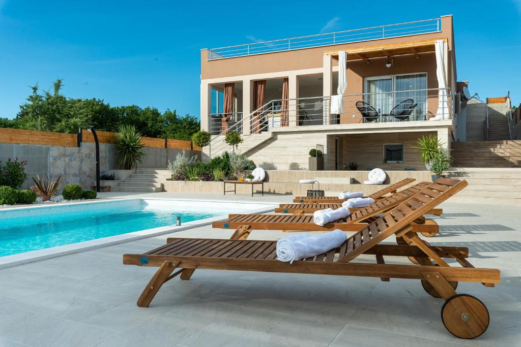 a villa with a swimming pool and a house at Villa Porta Maris in Zadar