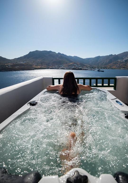 a woman is in a hot tub on a boat at Astrio Suites in Livadi