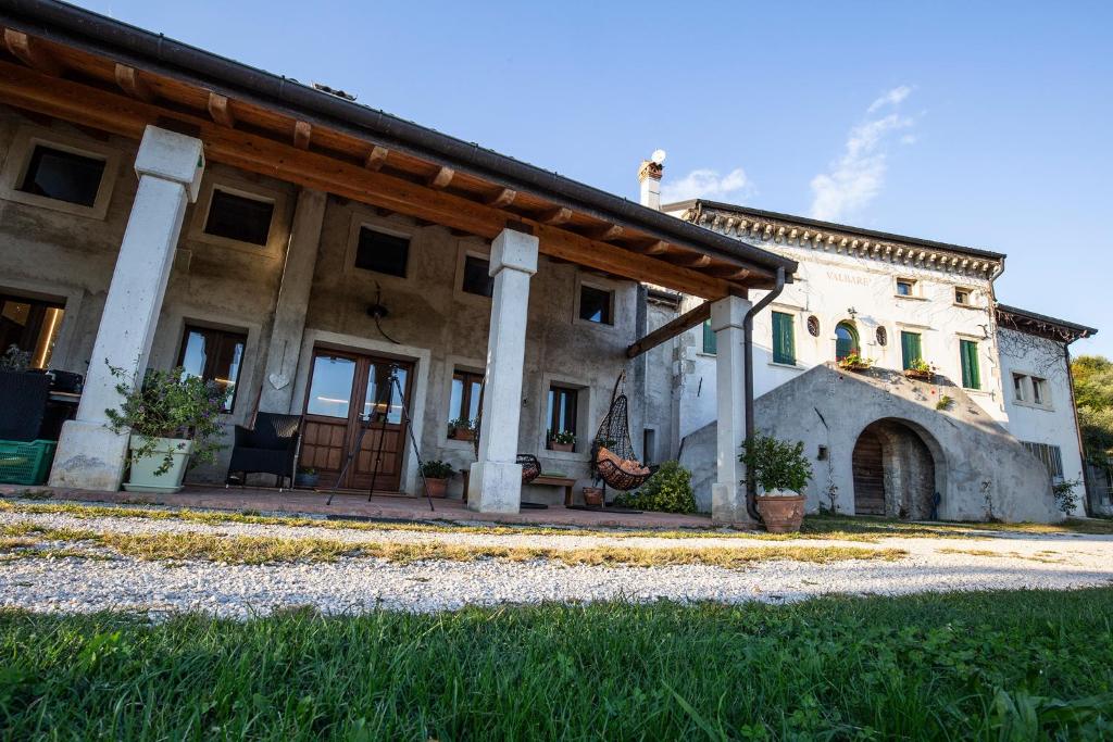 a large stone house with a wooden roof at Agriturismo ValBarè in Fregona