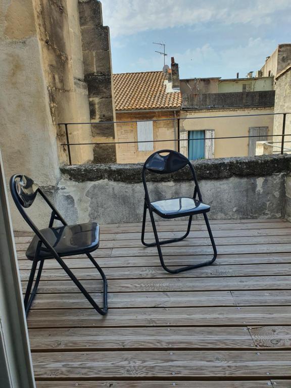 - deux chaises assises au-dessus du balcon dans l'établissement LIBERTE 17/3, à Arles